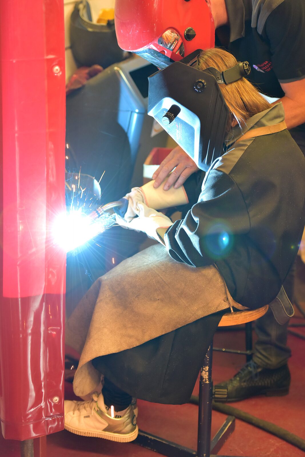 A welder at work, face behind a welding mask
